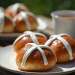 Freshly baked Quick Hot Cross Buns with icing crosses served with tea.